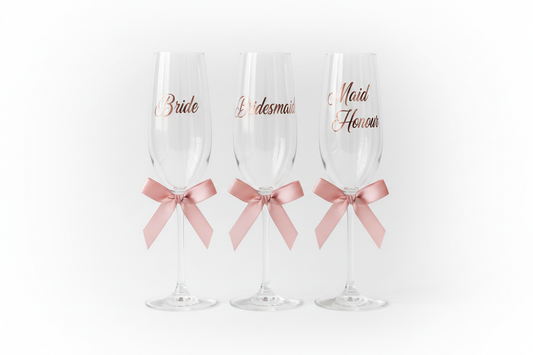 Personalised champagne glasses with vinyl text and ribbon bows